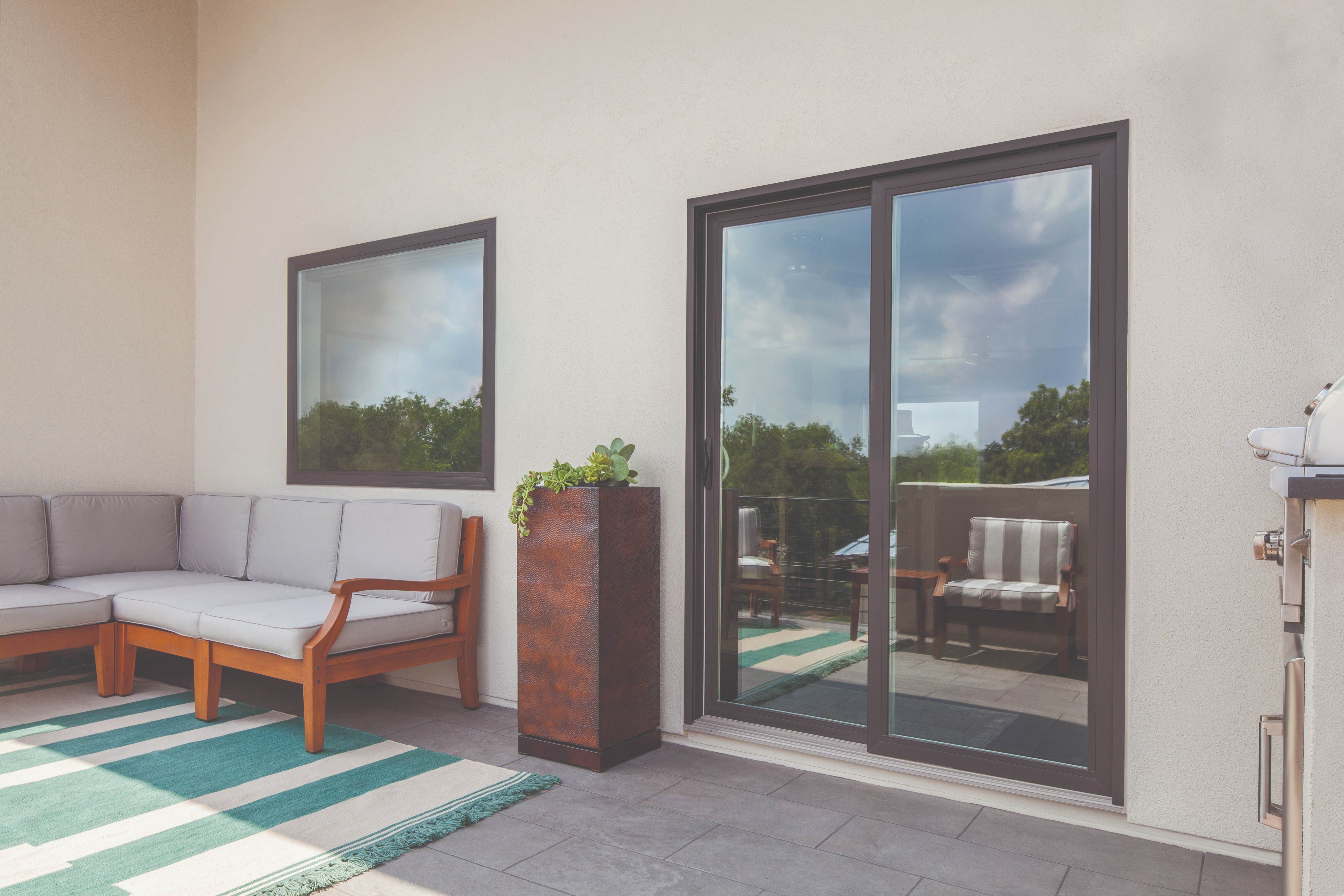 100 Series Gliding Patio Door - Modern patio with bronze sliding doors